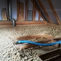 Log house attic insulation process with Steico Zell wood fiber wool